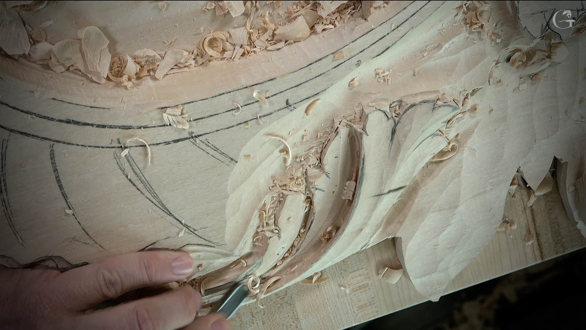 A close-up shot of a hand skillfully carving details into a wood piece. Shavings and curls from the wood are spread around, showcasing the craftsmanship involved. This image highlights a person engaged in wood carving, making it perfect for promoting wood carving classes and lessons!