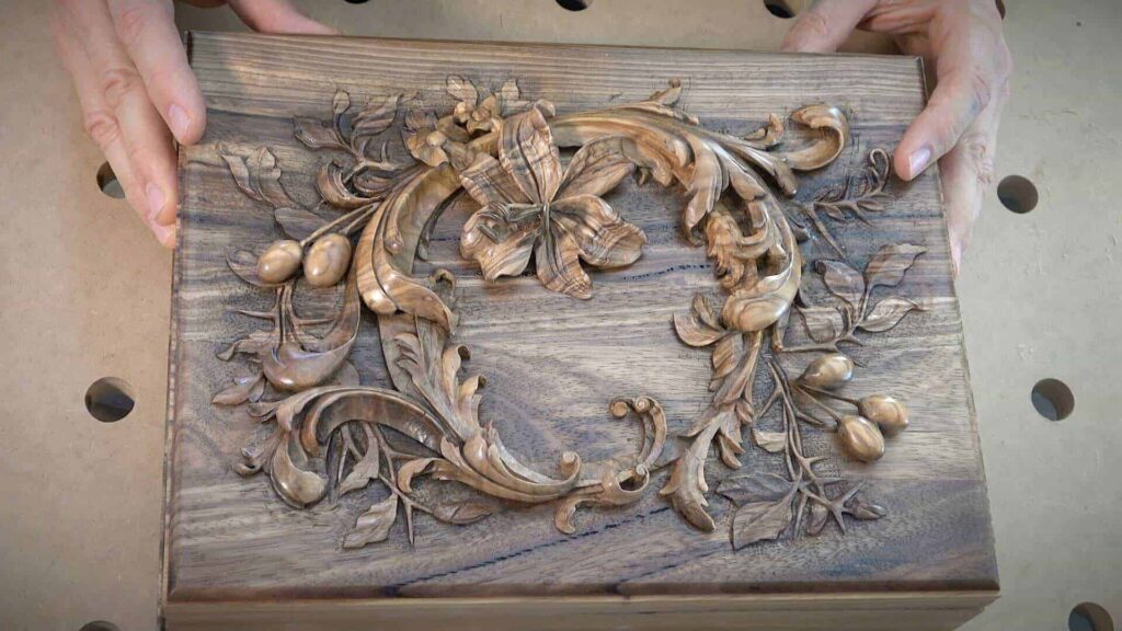 Alt text: A close-up of a beautifully carved wooden box featuring intricate floral and leaf designs. The craftsmanship shows attention to detail, highlighting the skill involved in the wood carving process. Ideal for showcasing wood carving classes and lessons for enthusiasts.