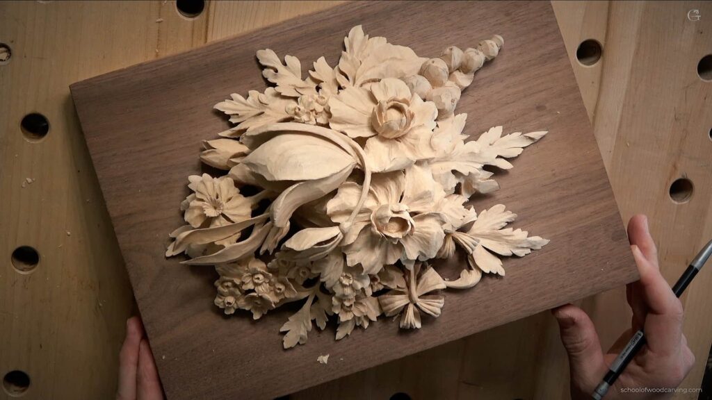 Alexander Grabovetskiy teaches techniques inspired by the Grinling Gibbons style of wood carving as he intricately carves flowers from a block of basswood. He utilizes a variety of carving tools essential for this elaborate craft, including sharp wood carving knives and gouges of various sizes, demonstrating advanced methods like chip carving. Alexander discusses the significance of selecting the right type of wood, often preferring those with beautiful grain and texture to match the intricate designs characteristic of Gibbons' work. He provides practical tips for beginners on sharpening blades to achieve precision in their carvings and selecting suitable tools from their beavercraft kit. By incorporating spoon carving and whittling techniques, he creates decorative wooden elements reminiscent of 17th-century architecture. His unique wood carving style emphasizes beautiful shapes and sculptural forms, reflecting the charm seen in Gibbons’ legendary pieces. On his YouTube channel, Alexander shares step-by-step instructions on various types of wood carving techniques, helping aspiring woodworkers develop their basic skills in creating ornate designs. This image captures Alexander’s dedication to mastering the Grinling Gibbons style, showcasing his expertise in producing stunning wood carvings that honor historical craftsmanship.