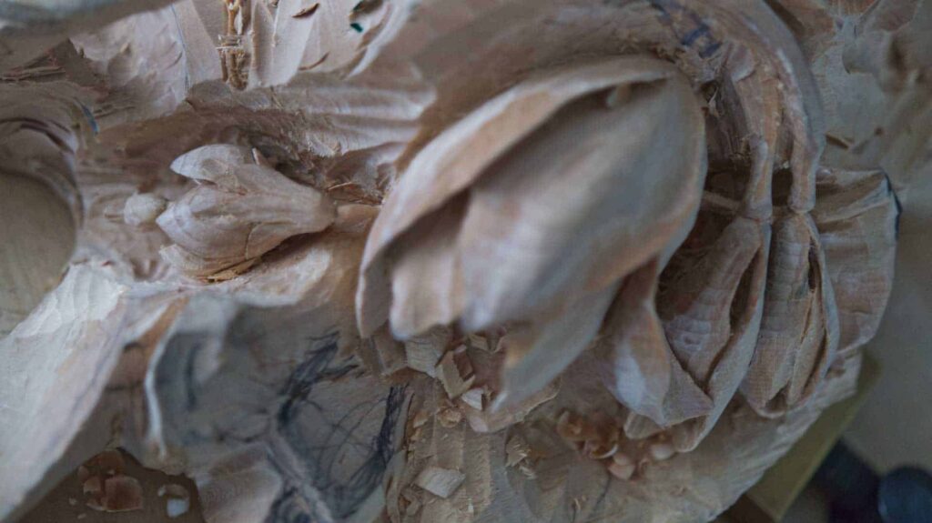 A close up of a wood carving of a flower available for online wood carving lessons.
