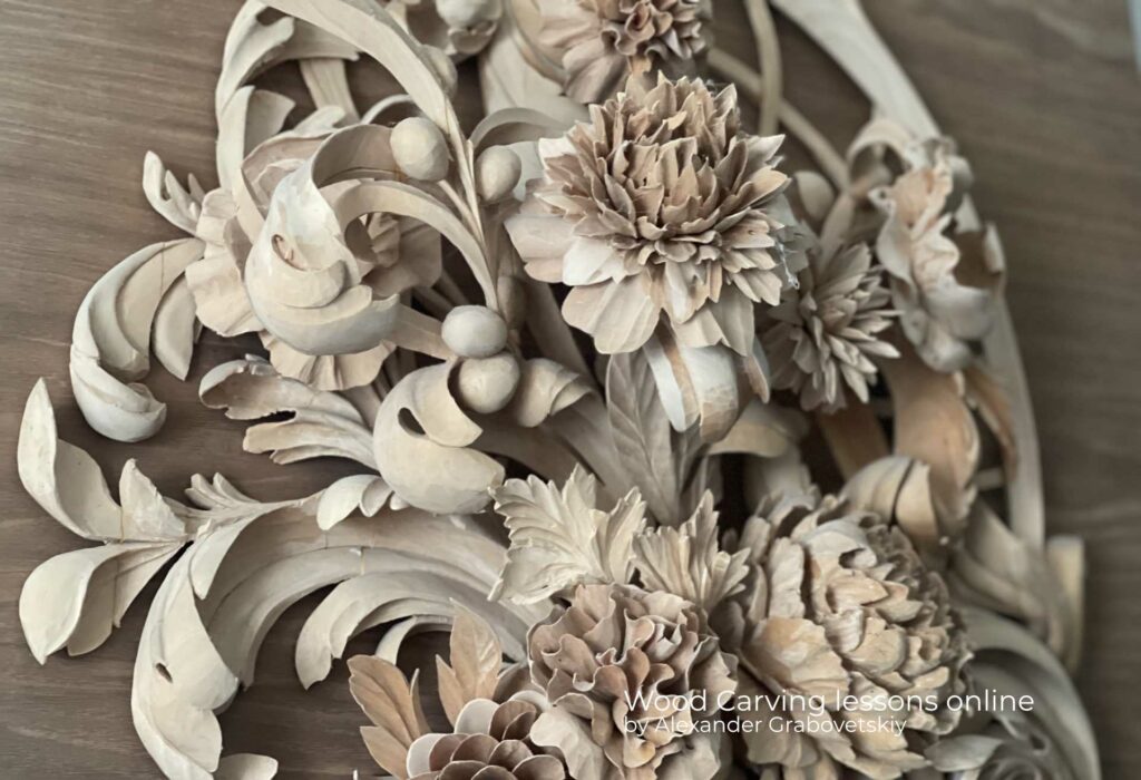A wood carving of flowers on a walnut surface.