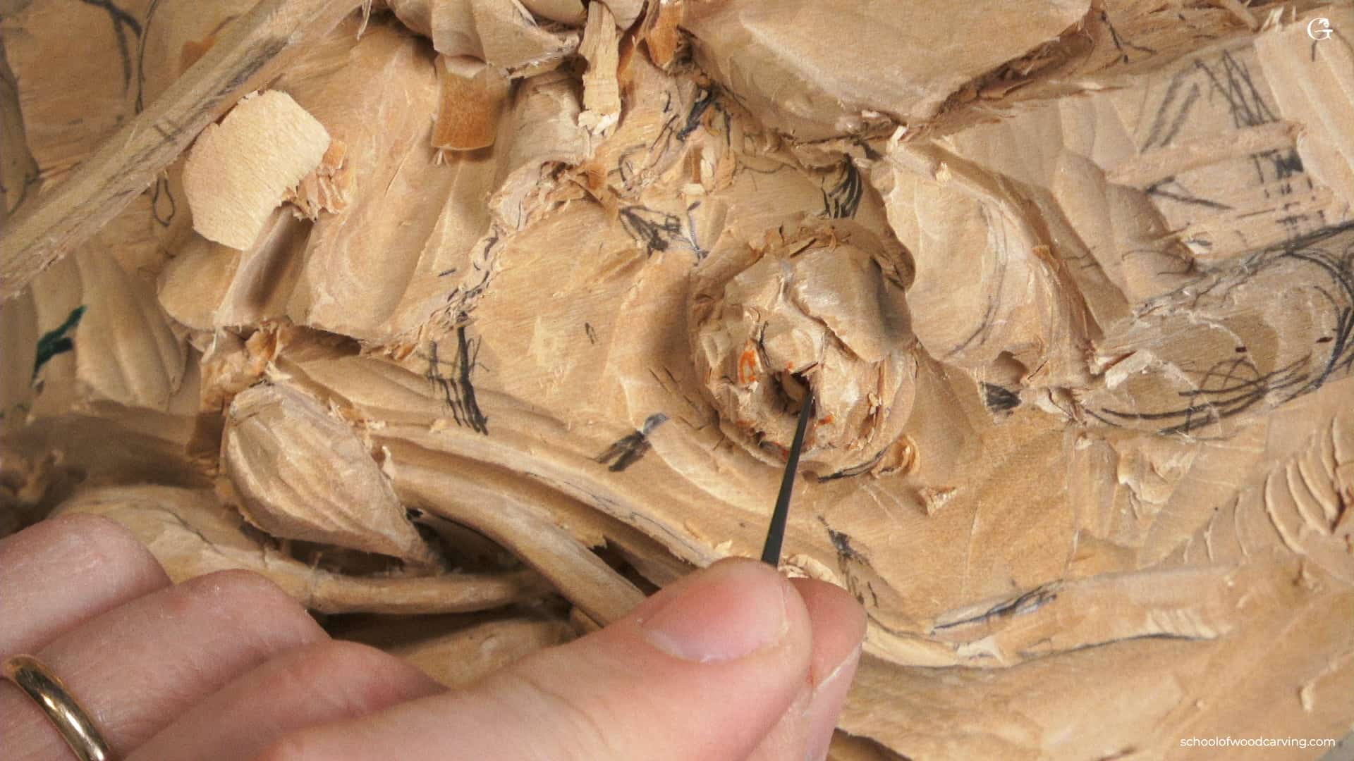 A person is using a tool to make a wood sculpture. How Wood Carving Boosts Your Brain Power