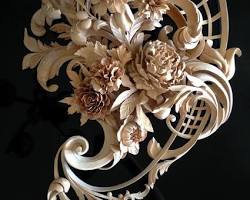 Alt Text: A beautifully detailed wood carving featuring elegant flowers and intricate leaf designs, showcasing the artistry involved in wood carving classes and lessons.