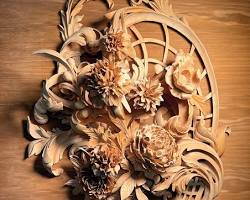 Alt text: A beautifully detailed wood carving featuring flowers and leaves, showcasing the intricate design work often taught in wood carving classes and lessons.