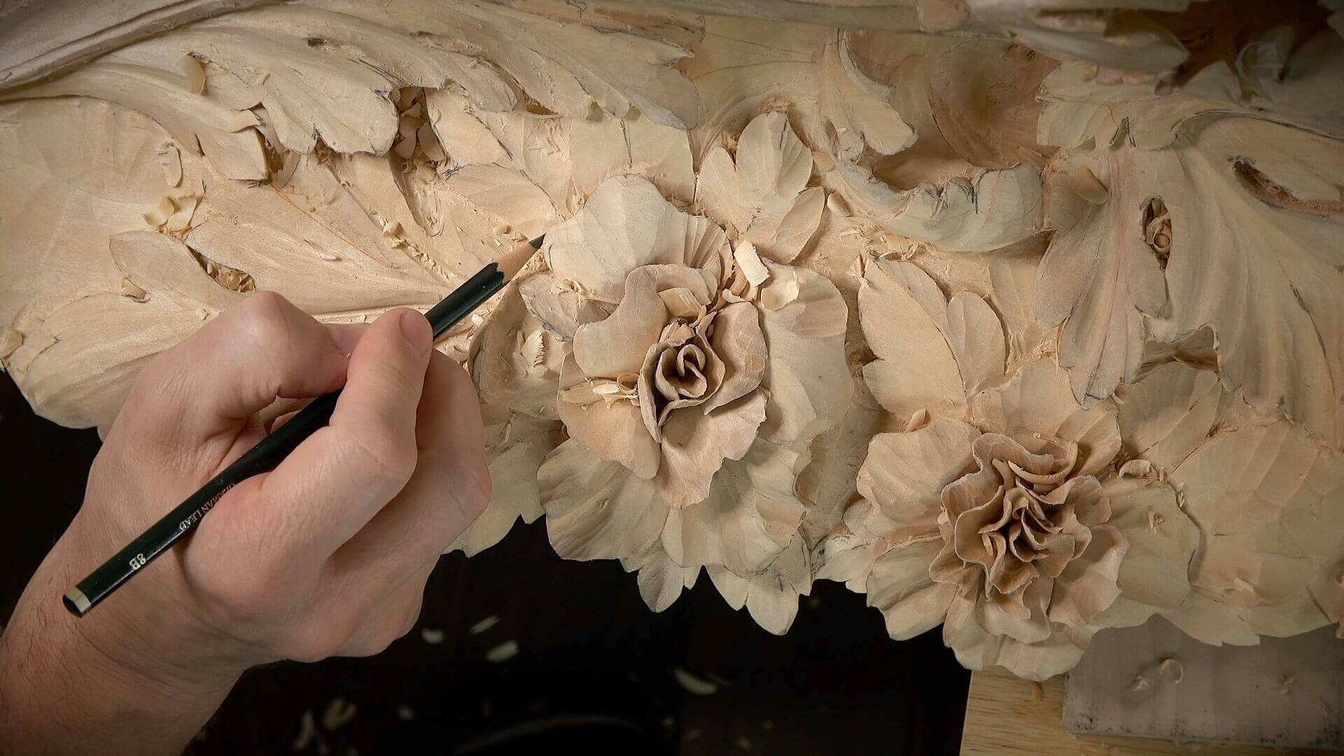 Alexander Grabovetskiy is carving flowers for a client, demonstrating various wood carving techniques. This image highlights how to make money carving wood, focusing on the art of woodworking and woodcarving. As a dedicated woodworker and carver, he transforms a block of wood into an object of beauty, showcasing chip carving and the skill required for creating unique pieces. The image emphasizes essential aspects of starting a profitable woodworking business, including the right tools for projects, selling wood products, and participating in local craft fairs. It reflects entrepreneurship in the woodworking field, marketing carved items through social media and online marketplaces like Etsy, while appealing to potential customers who are willing to pay for handmade art and furniture. This scene captures the essence of turning a hobby into a profitable venture, making decent money from wood carving, and the joy of creating beautiful pieces from scrap wood or specialty tools.