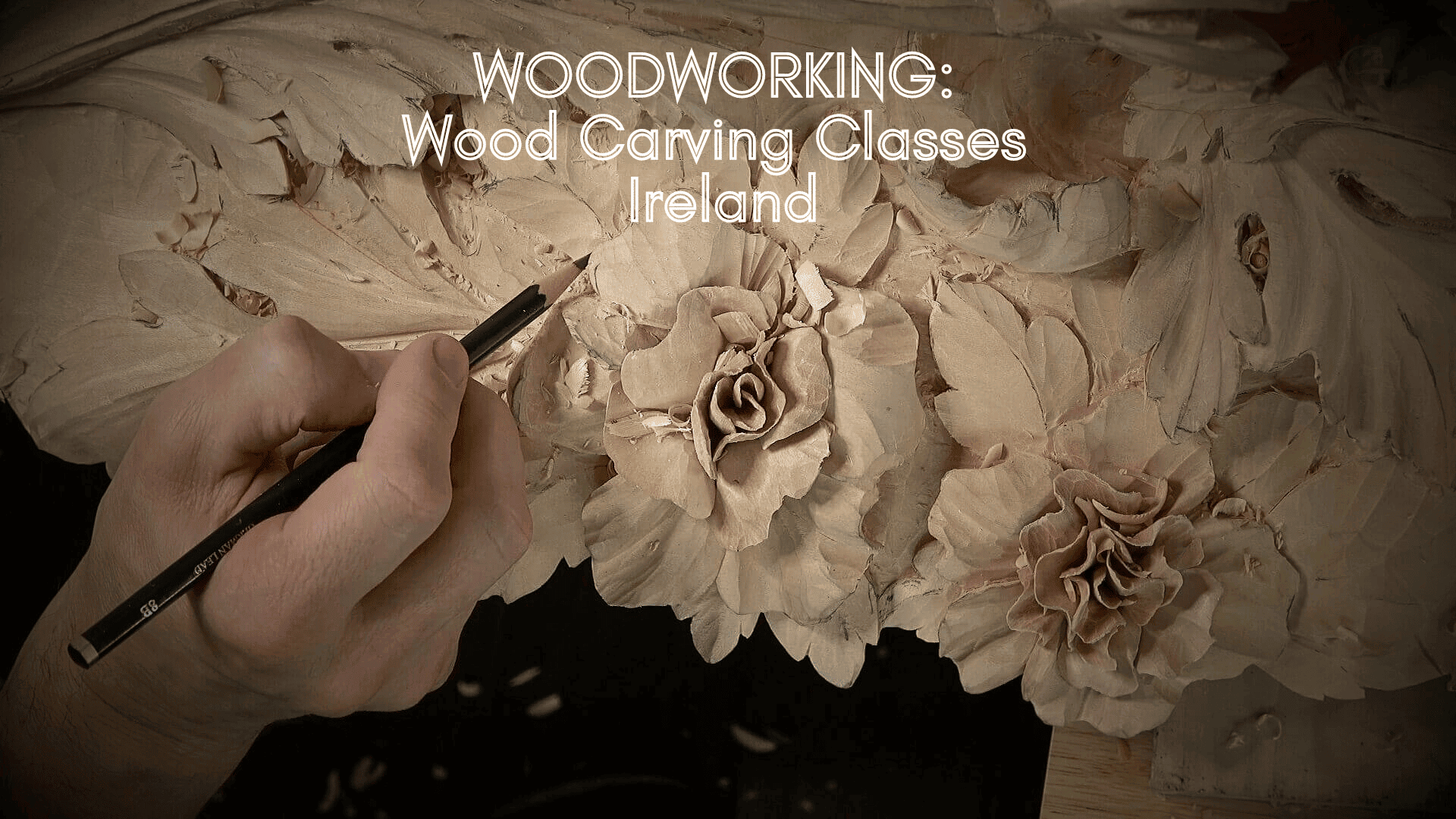 Alt text: A close-up of a hand delicately carving floral patterns into wood, showcasing a wood carving project. The image promotes wood carving classes in Ireland, highlighting the artistry involved in wood carving lessons.