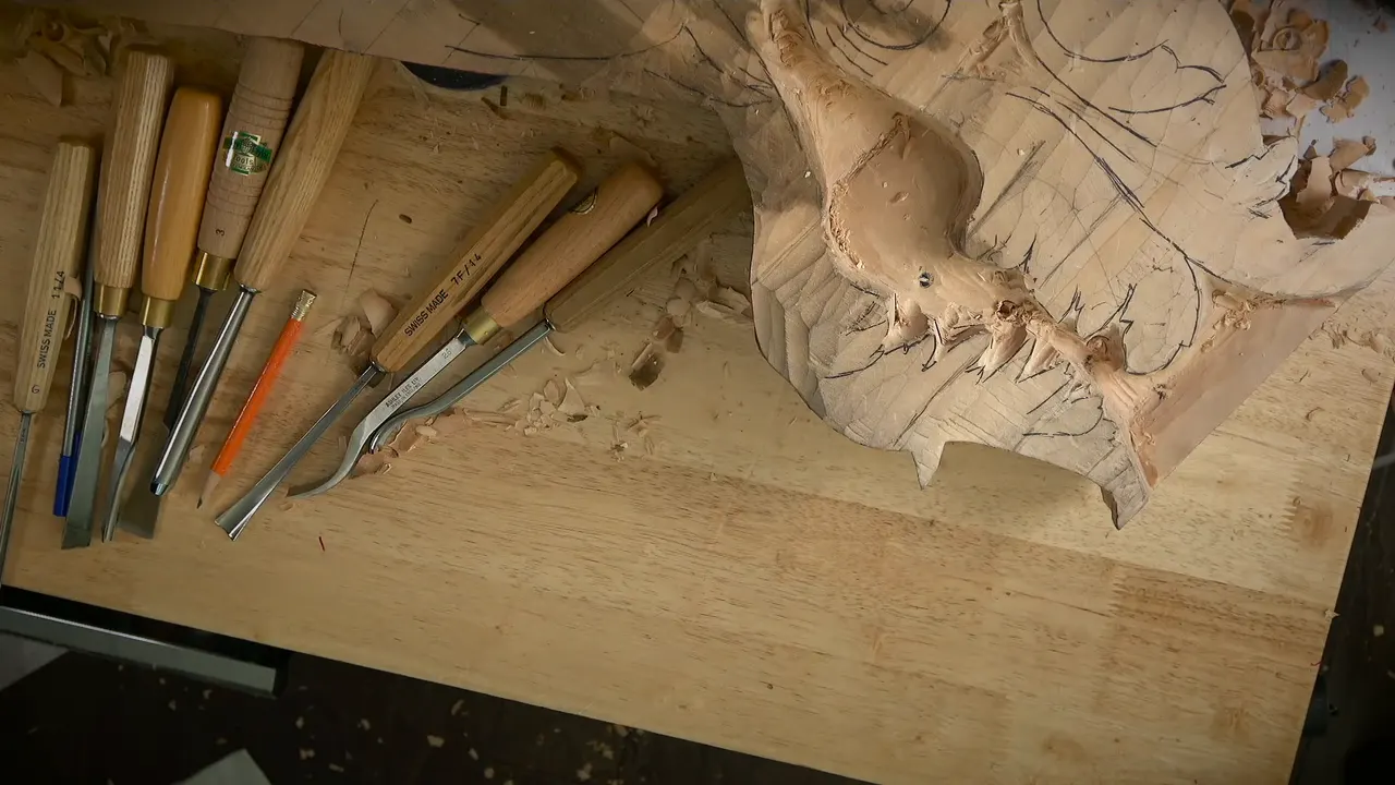 Gouges on the bench beside the carved drop, a small drilled hole in its hollow