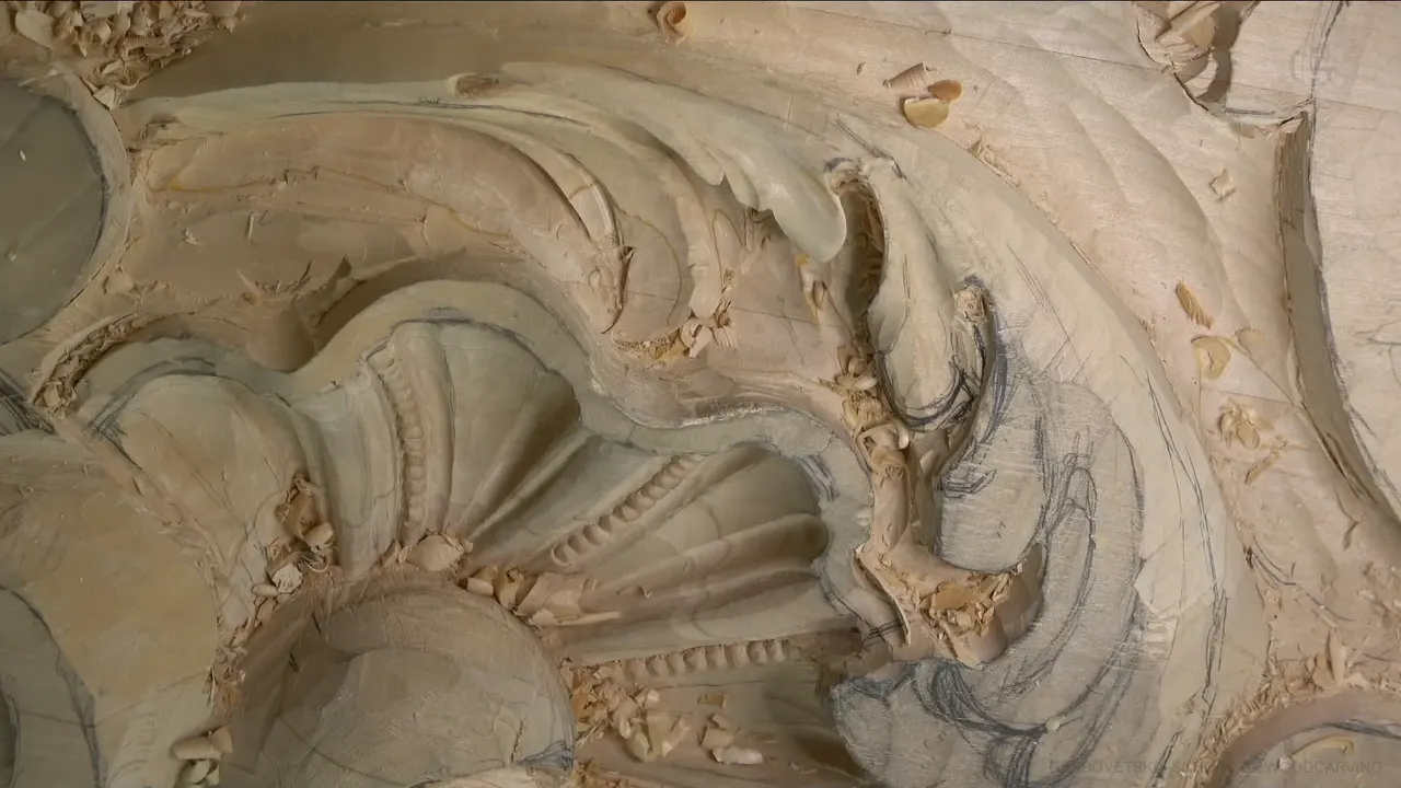 Venice panel acanthus leaf curling over a fluted shell, with pencil lines and fresh chips around it