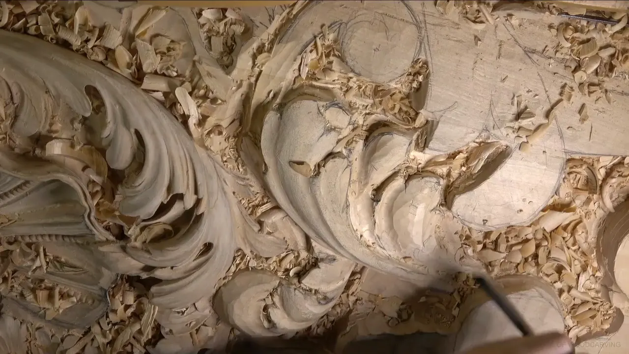 Roughed-out acanthus leaf with its hollows and ridges carved, pencil lines still marking the part that comes next.