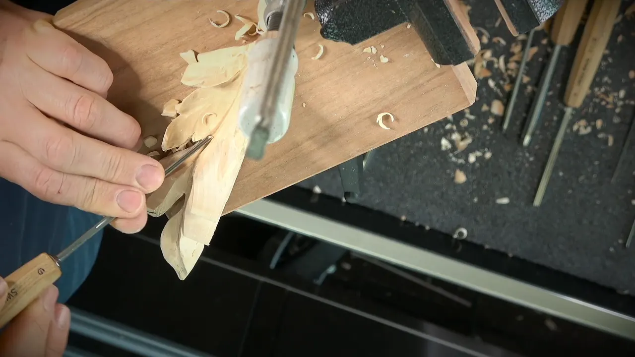 Handle stamped Swiss Made held low against the leaf edge