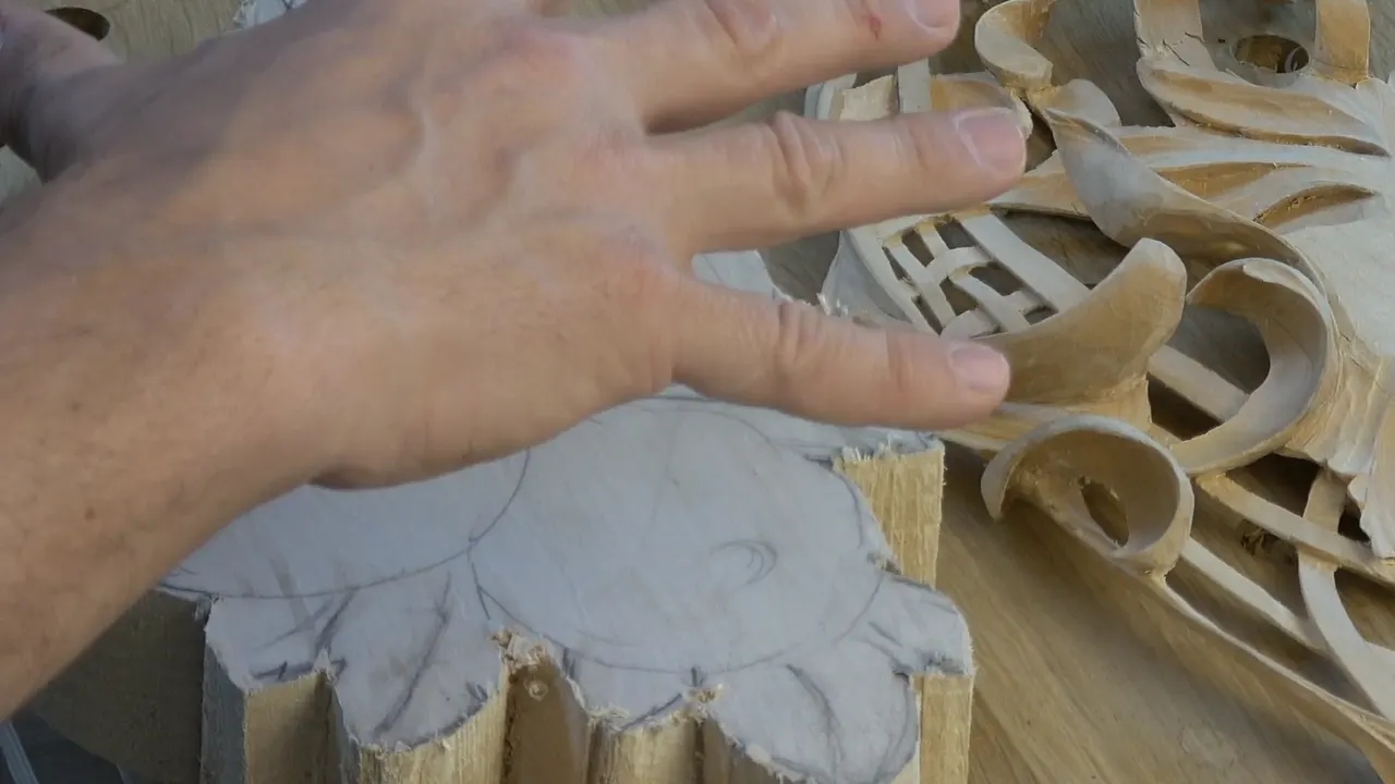 A hand holding the sawn second layer blank down over the finished first layer to see how the two sit.