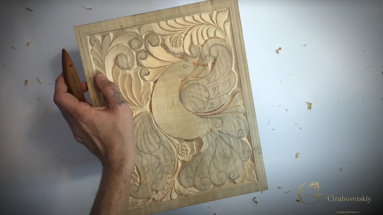 Carved bird tail marked into four matching sections in pencil before carving begins.