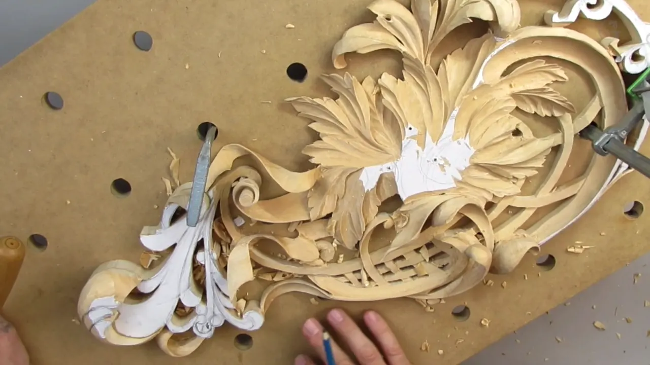 The whole pierced panel clamped flat on the drilled board, chips everywhere, claw at the near end.
