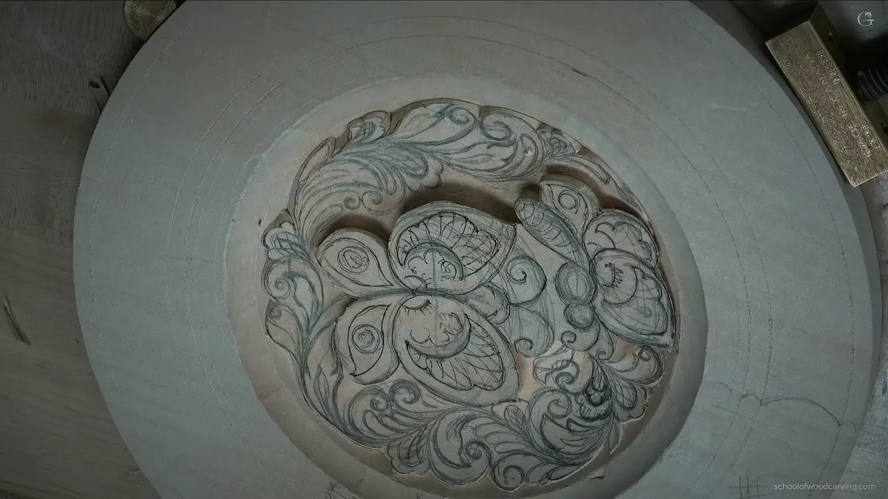 From above, the design sits in its dish with the outline carved around it