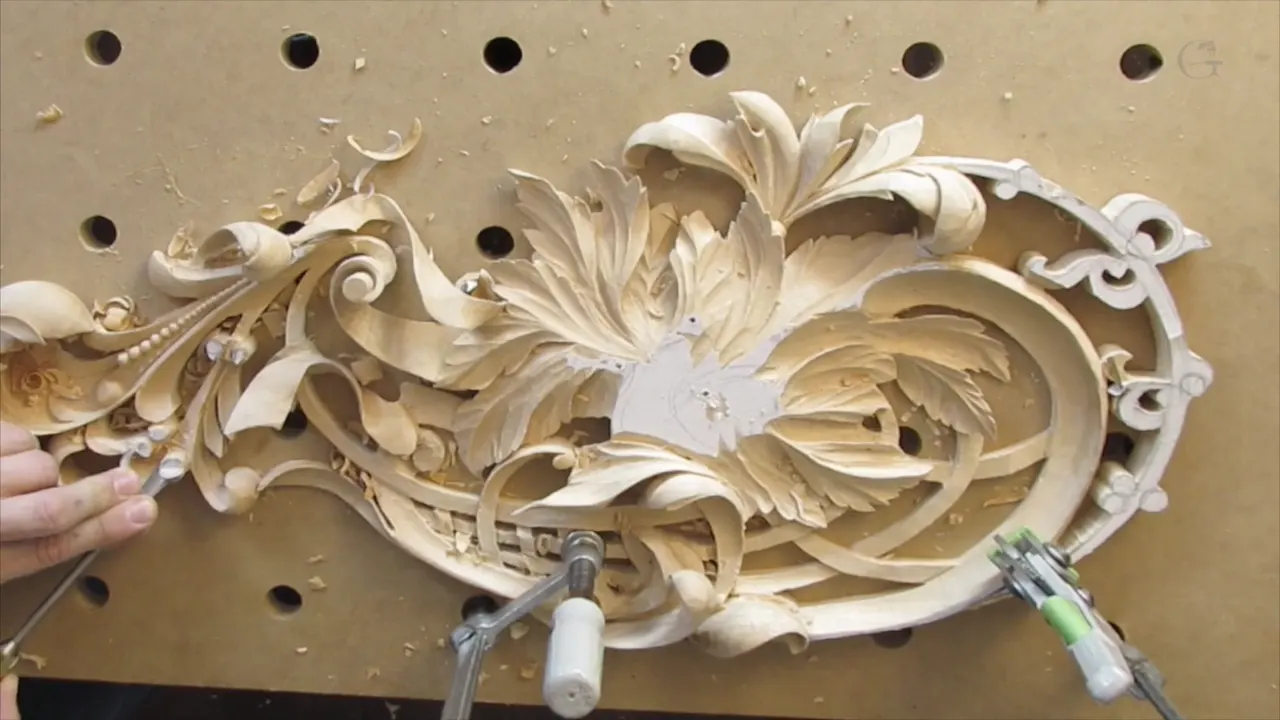 The finished row of beads running along the curve, panel clamped flat to its drilled board.