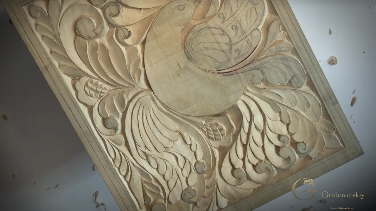 Carved wing at the end of a session, shallow work throwing a long shadow across the panel.