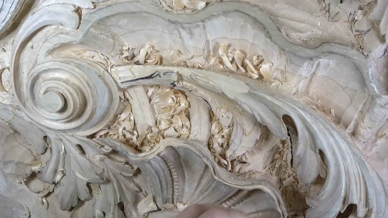 The scroll, acanthus leaves and shell from above, chips still lying in the hollows.