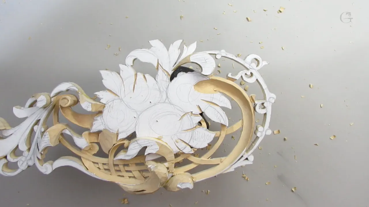 Carved basket weave under a bank of leaves, pattern paper still on the uncut faces
