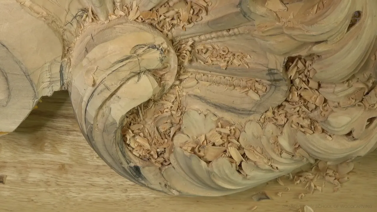 Lime acanthus head on the bench, a big curl beside a beaded shell.