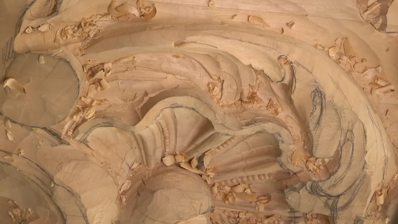 The half carved panel with its ribbed shell, deep leaf pockets and chips all over.