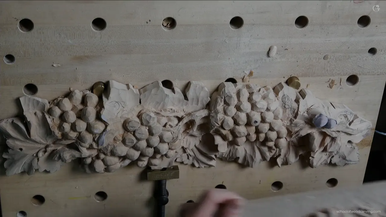 Whole panel from above with both grape clusters carved and the leaf section still waiting