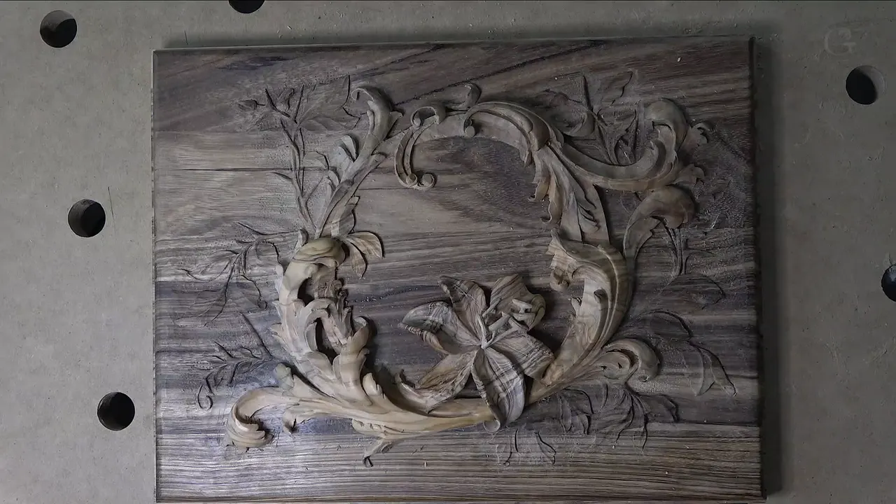 Straight down on the carved lid, with the lily low inside its scrolls.