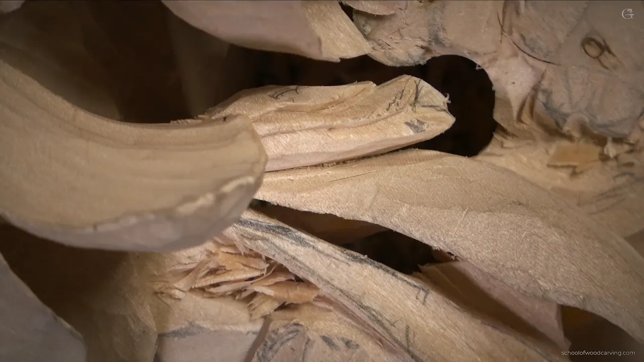 Dark opening behind a carved leaf on the Grinling Gibbons panel, the walnut showing through where the wood was taken away