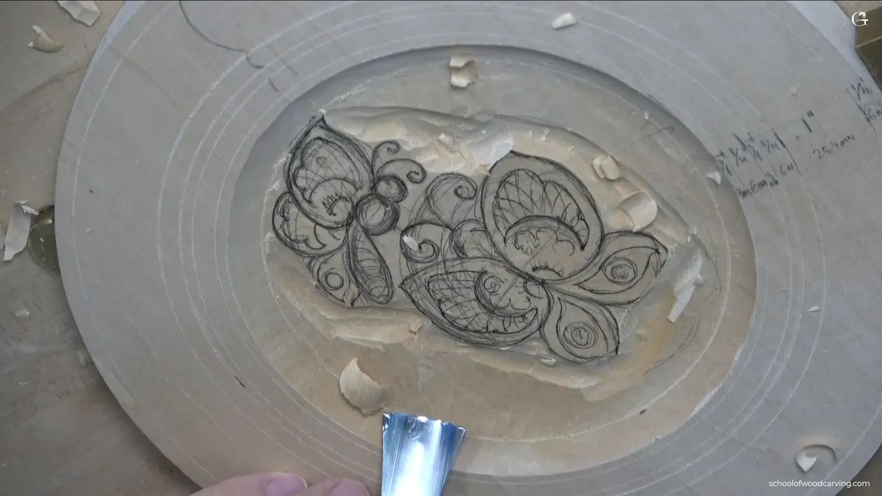 Both butterflies inked in the dish, with the ground around them already lowered by a gouge.