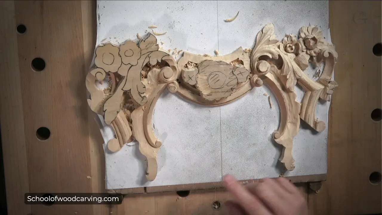 Clover molding carved along the panel, three convex faces running side by side with a small volute at the end