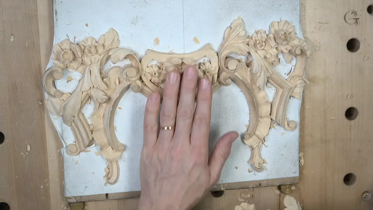 Both mirrored carvings laid on the bench together with his hands resting between them