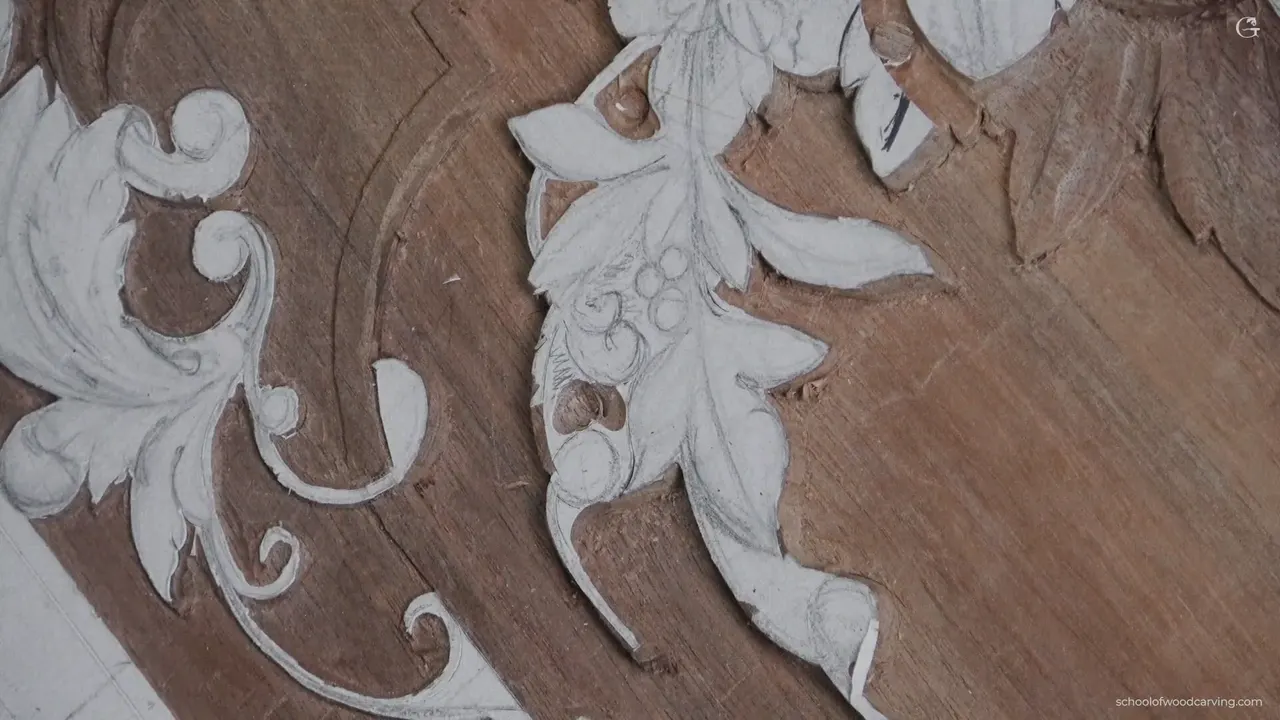Acanthus scrolls and small carved berries, standing barely proud of the board.