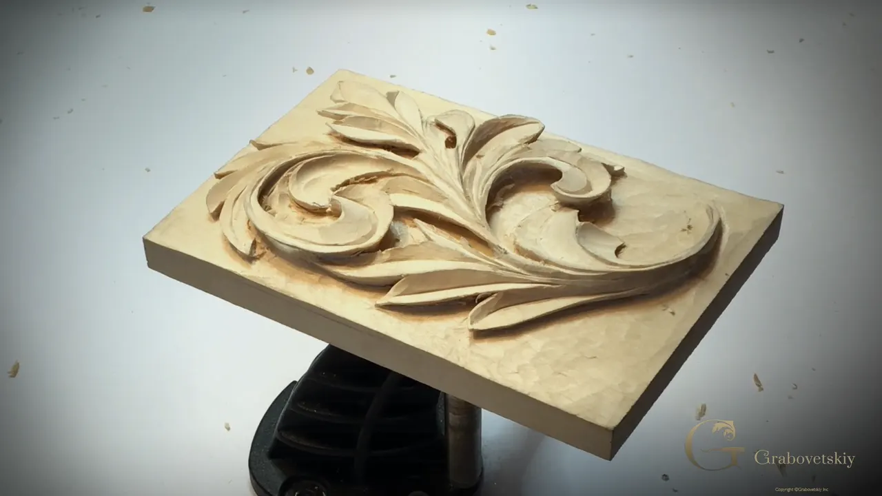 Finished Greek acanthus leaf on the bench vise, three quarter view, with nobody's hands in the frame