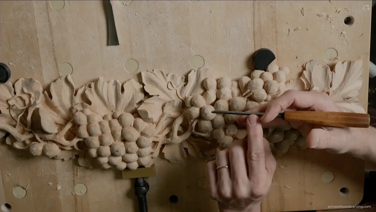 Both hands on a small tool, the way they sit for every fine pass on this panel