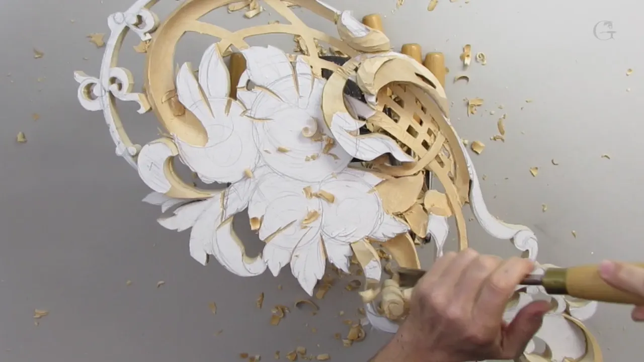 Carved spiral in limewood, pattern paper still covering everything not yet cut