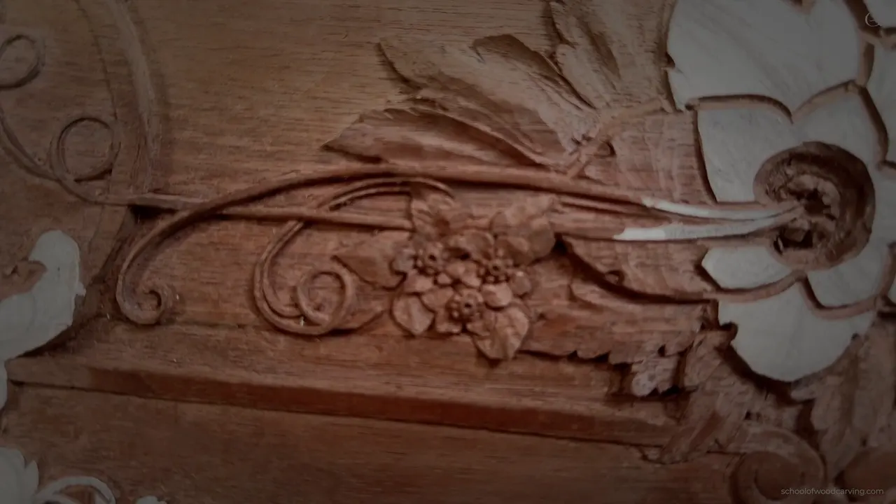 The finished section of the panel seen at an angle, scrolls and flowers together.