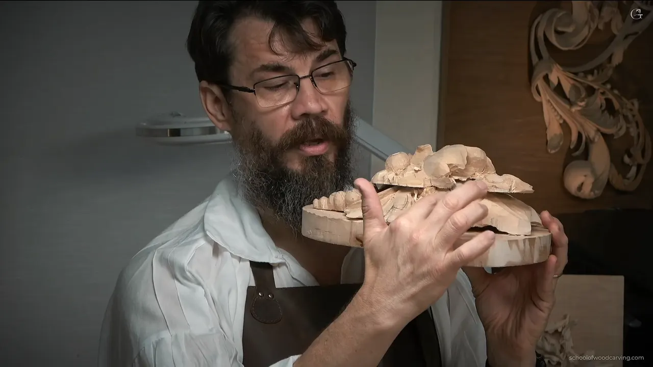The carving held up edge on to the camera, where the two glued boards are plainly visible as two boards