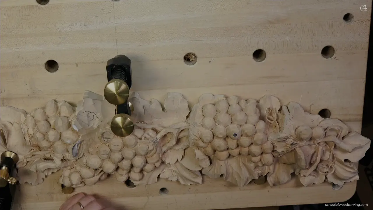 Whole panel from above with brass weights holding it, the vine now running the full length