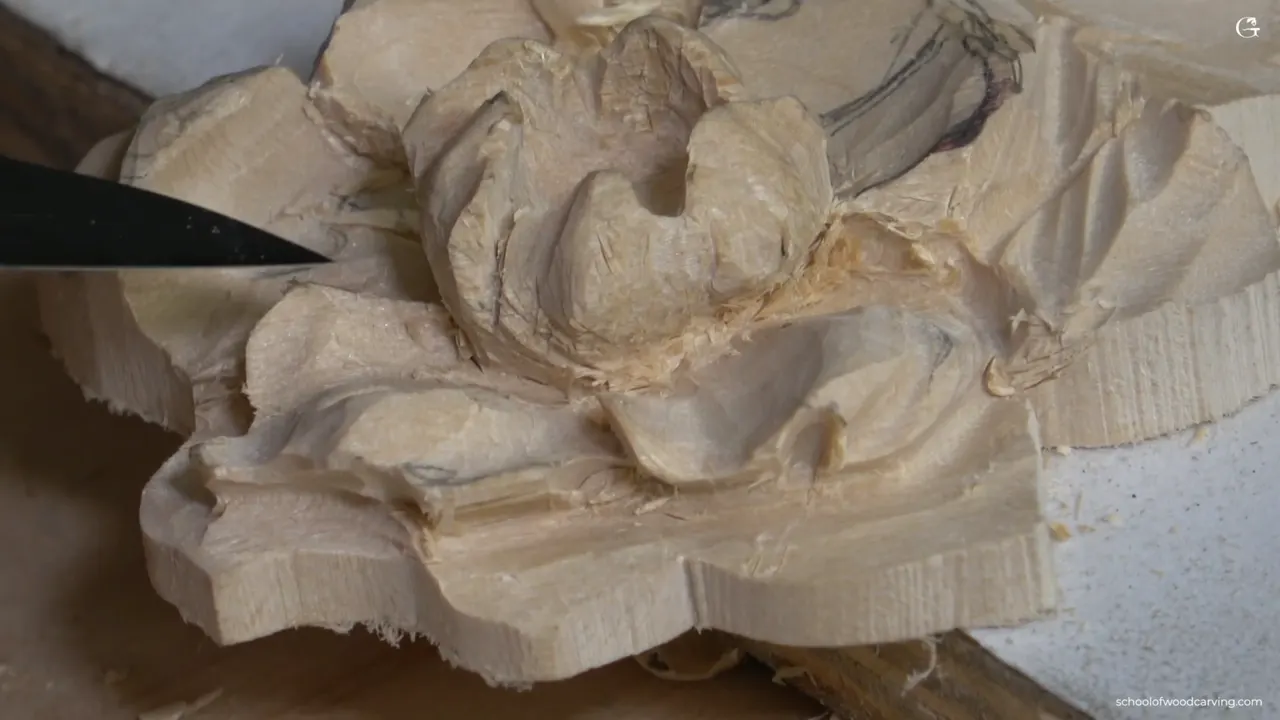 Knife blade laid against the carved rosette, every petal running down to meet at the middle.