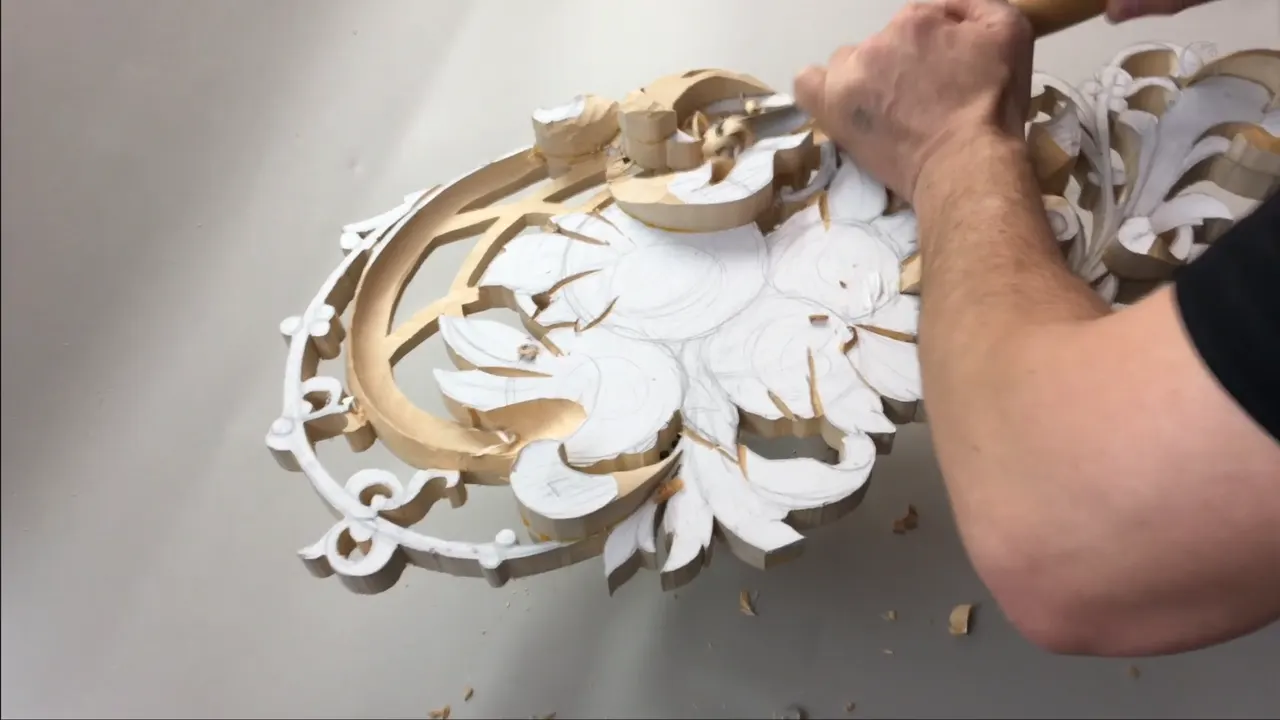 Pierced limewood panel with white pattern paper still covering the uncarved surfaces