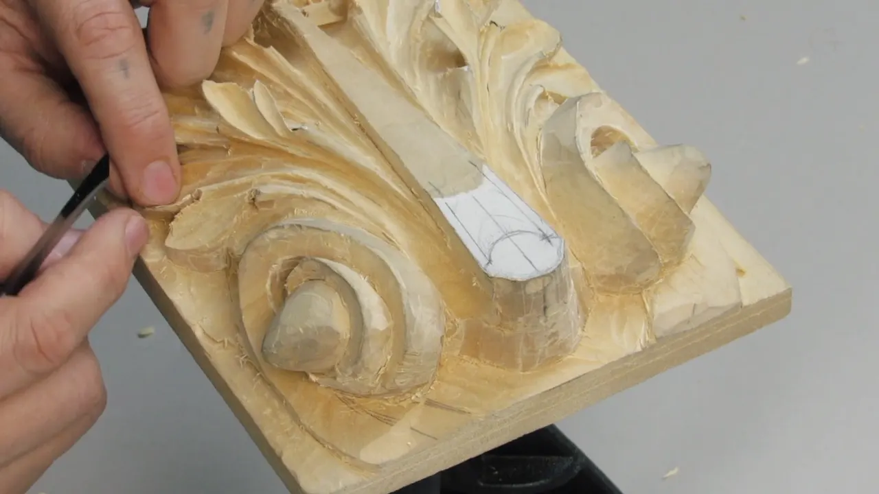 Panel tilted up on the vise with the carving deep enough now that the upper leaves stand clear of the ground