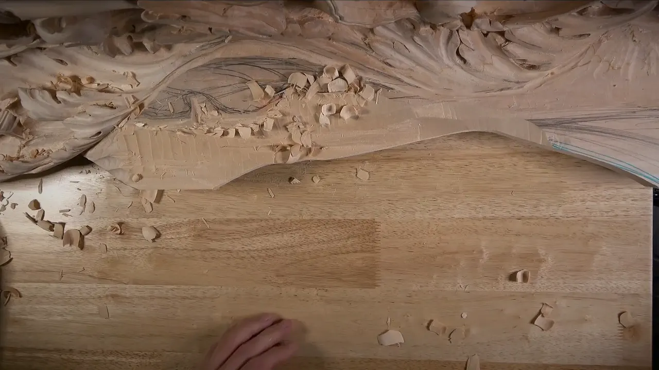 Roughed slope under a drawn acanthus, chips left in the hollow