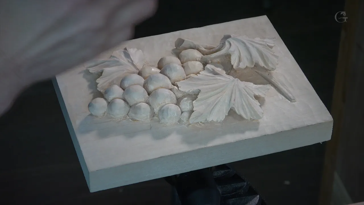 Finished basswood panel held in one hand.