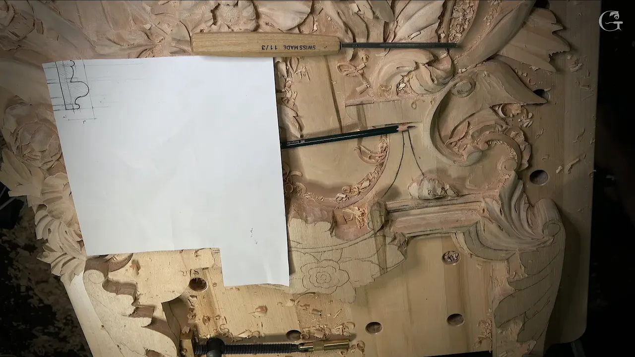 White sheet with the molding section drawn on it, a Swiss made chisel and a pencil lying on the panel