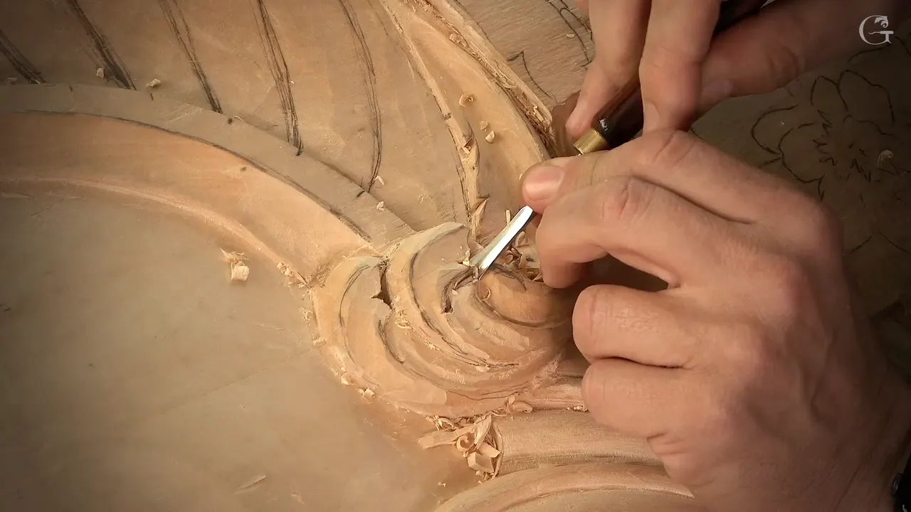 A small tool resting in the spiral of the curl, fingers steadying it from above