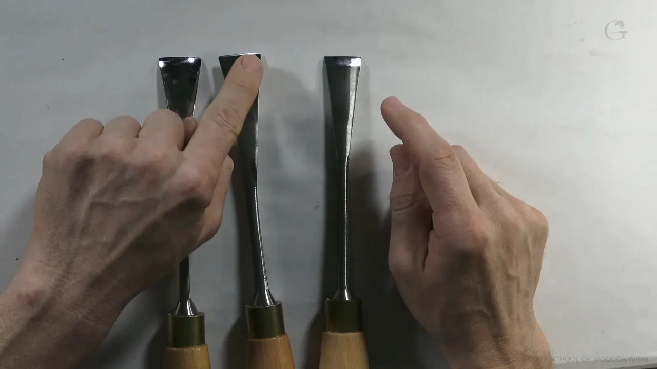 Three number three gouges stood upright, each ground with a different bevel.
