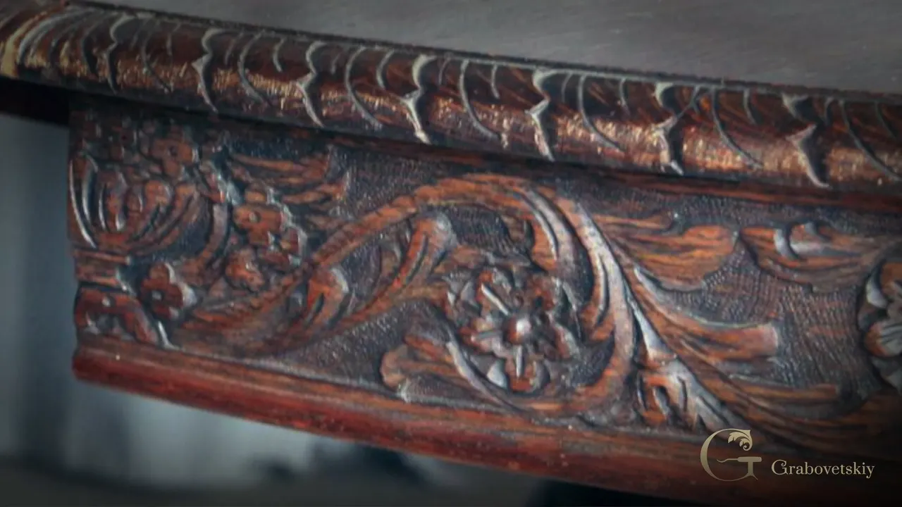 Old original, stained dark, a dotted ground behind its flowers and scrolls