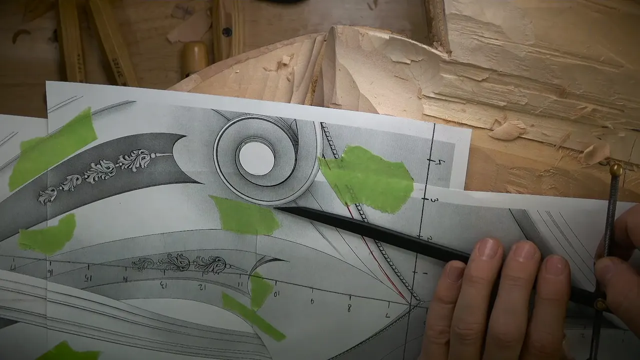 Paper print of a volute taped down with green tape, fingers holding caliper legs at its edge