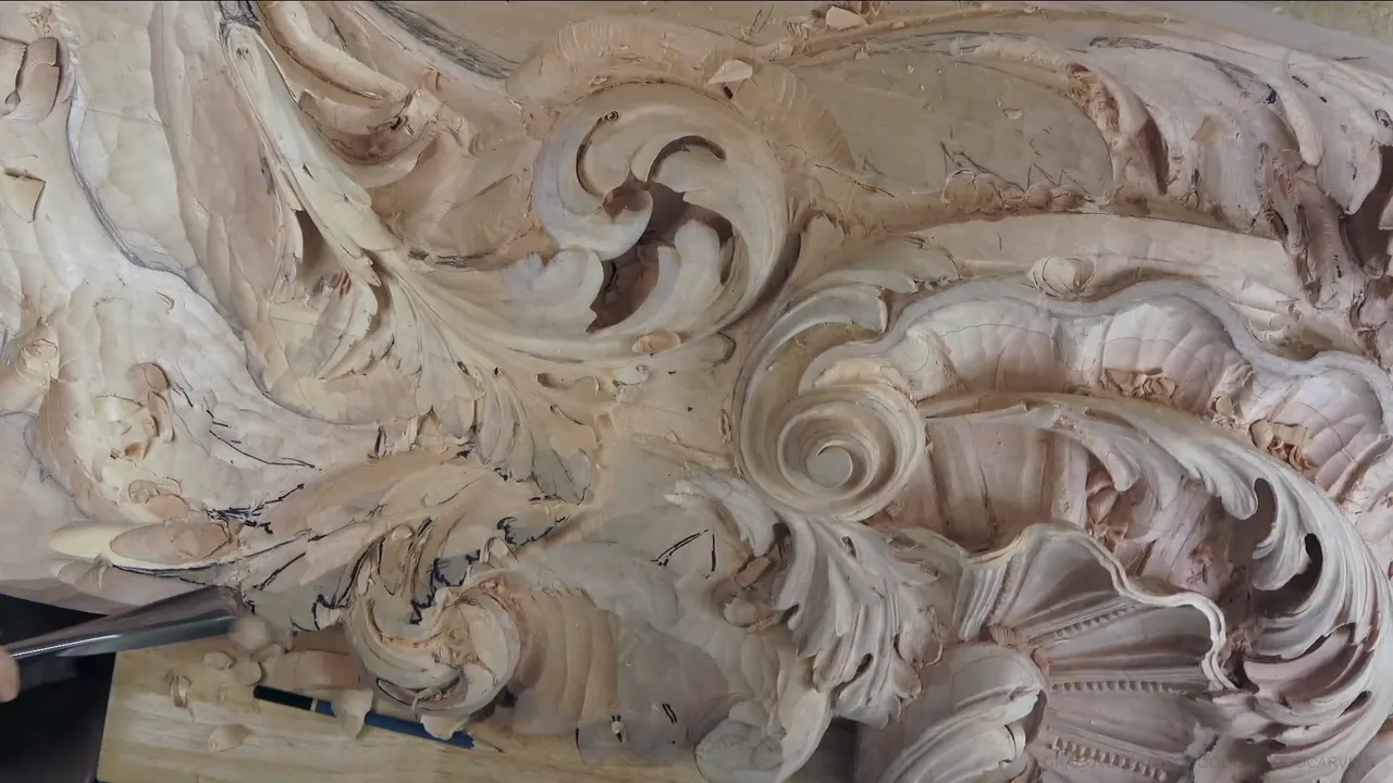 Carved shell and scrolls beside the rough acanthus curl, a steel blade coming in from the left.