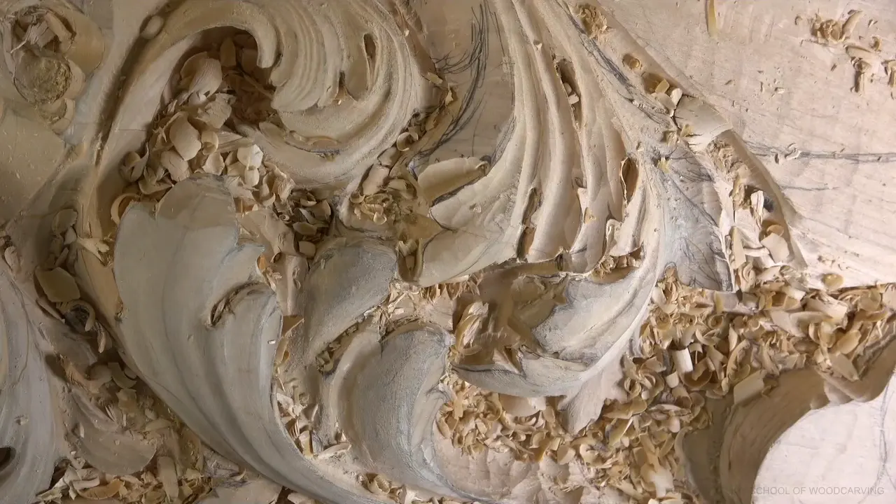 With no hands in the frame, the leaf shows deep hollows and pencil lines on the flat wood.