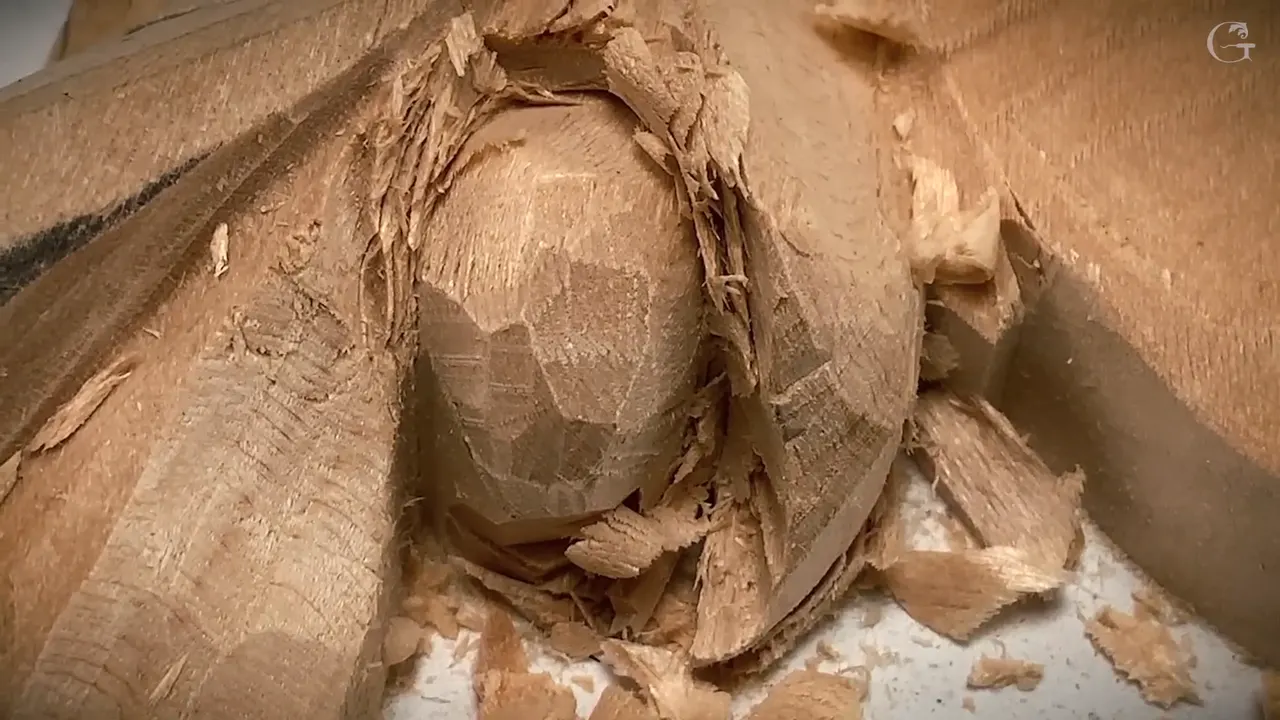 Close up, flat gouge facets still show on the berry with chips packed around it